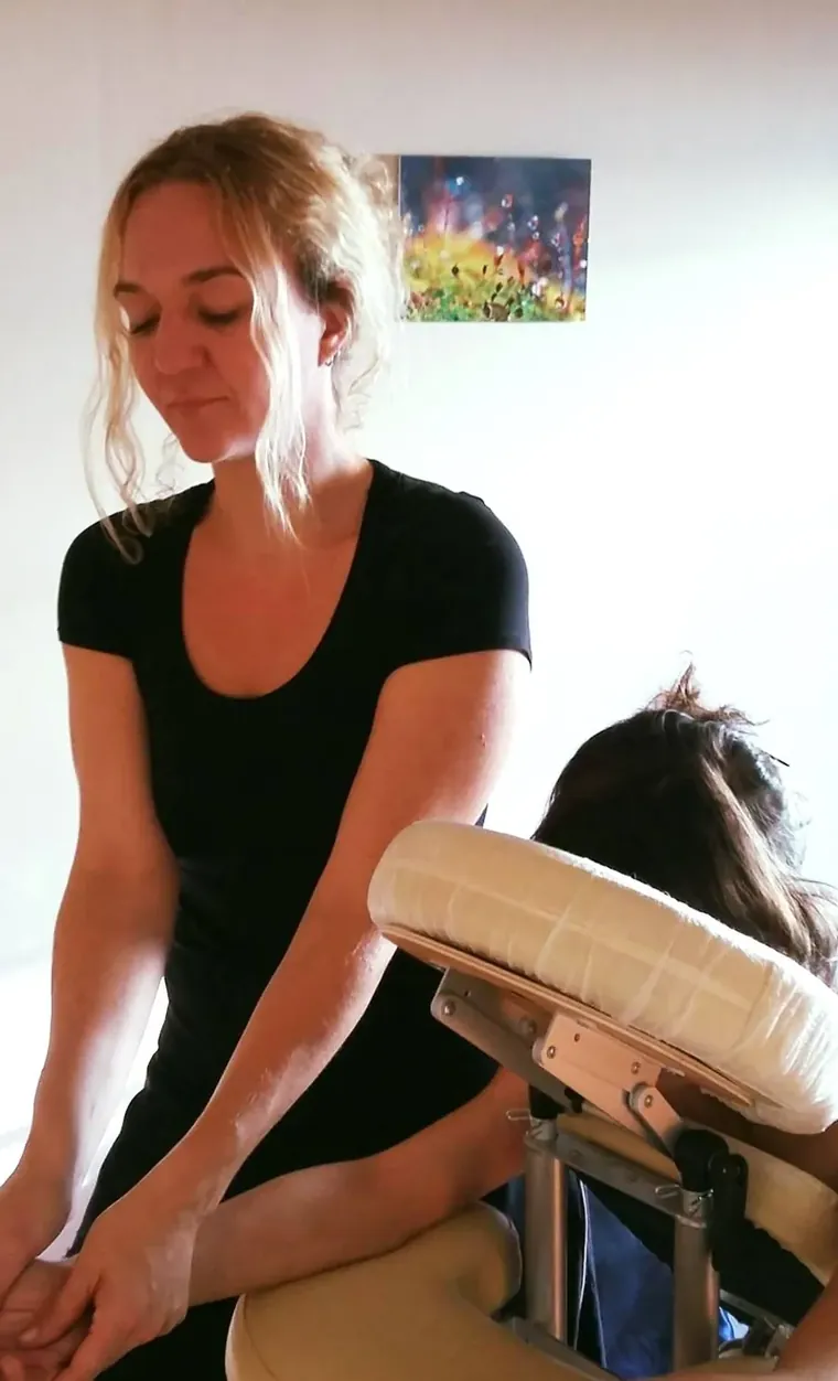 Claire pratique un massage Amma sur une personne assise en chaise